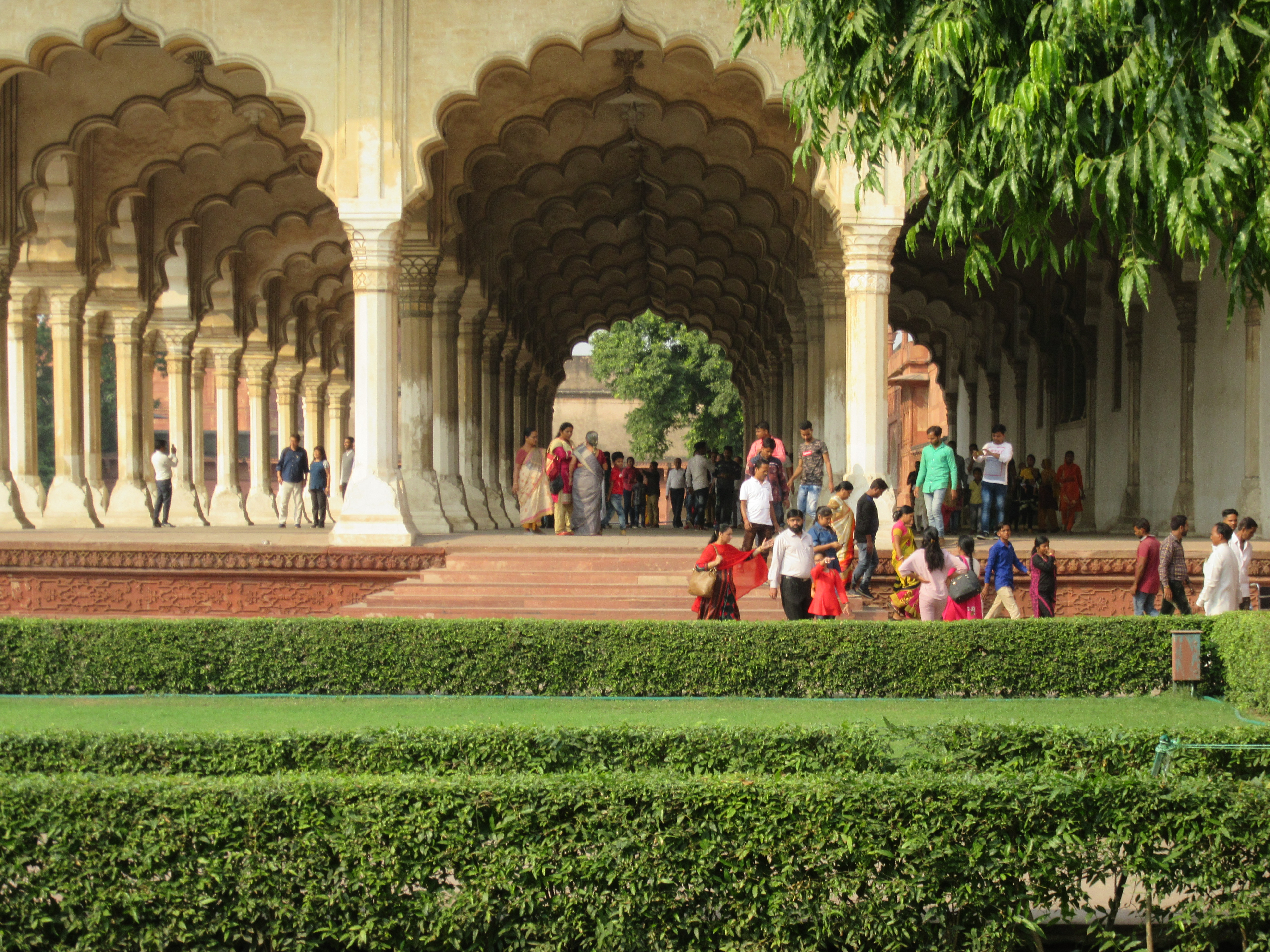 a group of people standing in front of a building, India