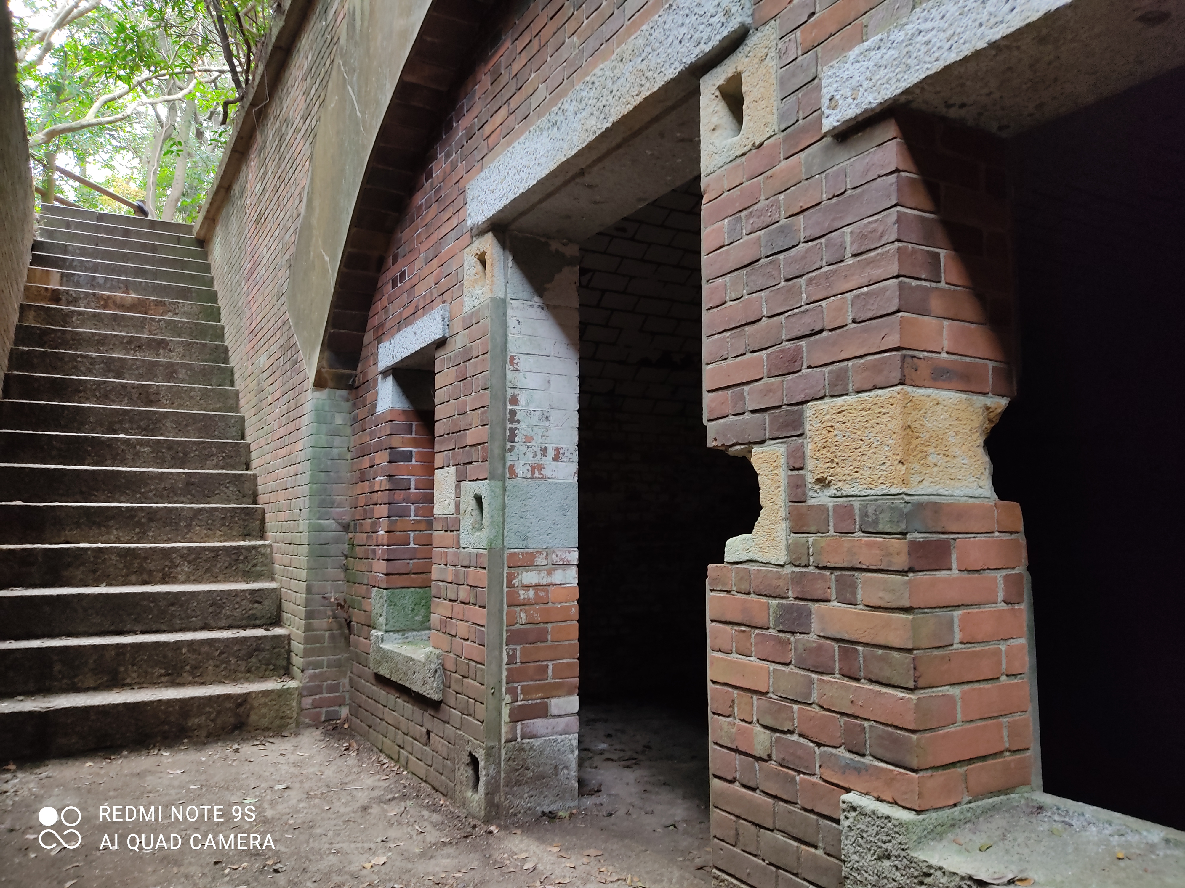 an old brick building with stairs leading up to it