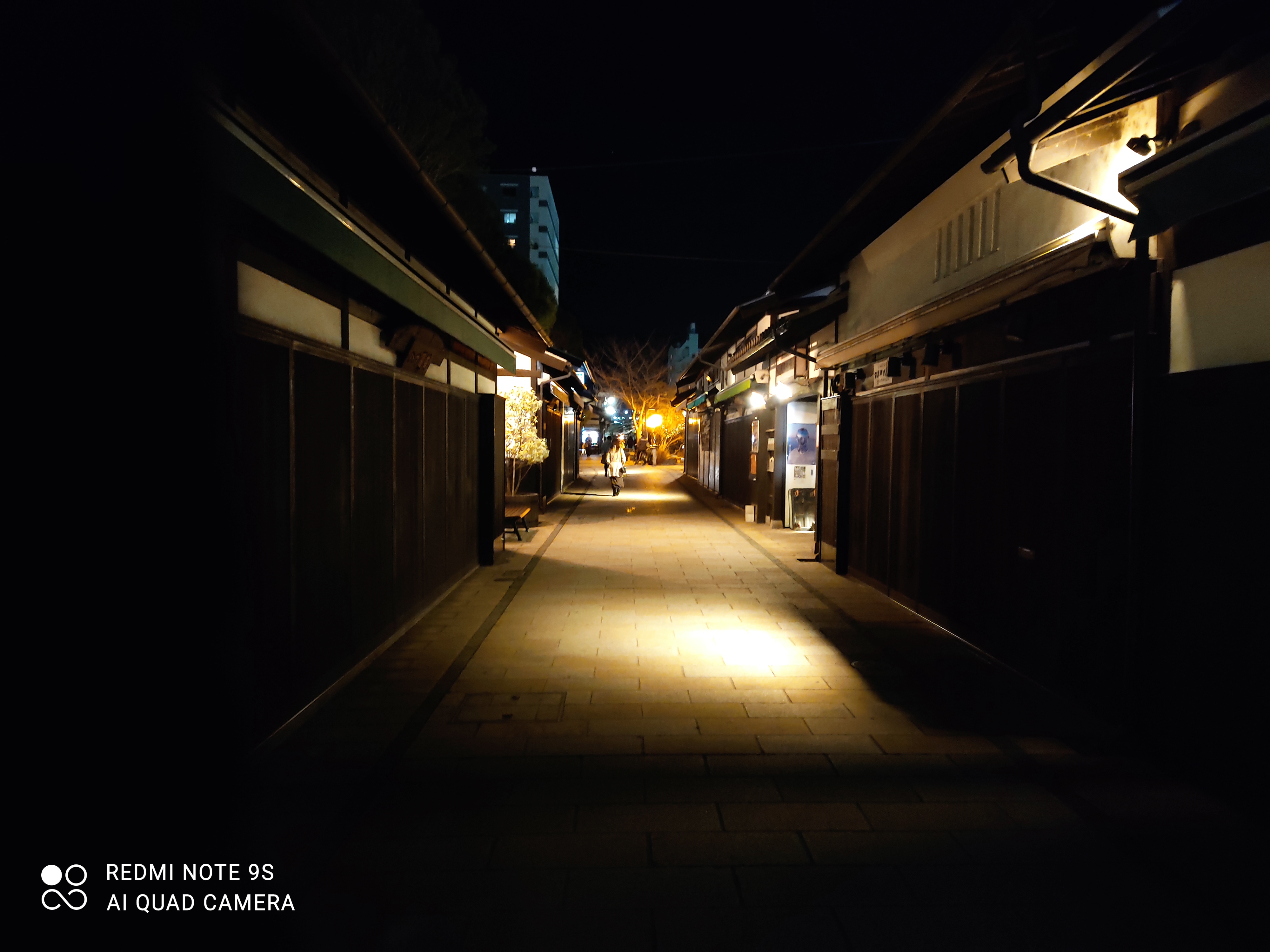  dimly lit streetMatumoto Nagano, at night with buildings in the background