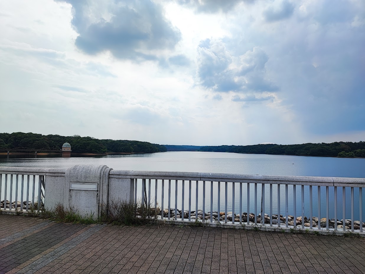 Lake Tama Tokyo, a large body of water sitting next to a metal fence