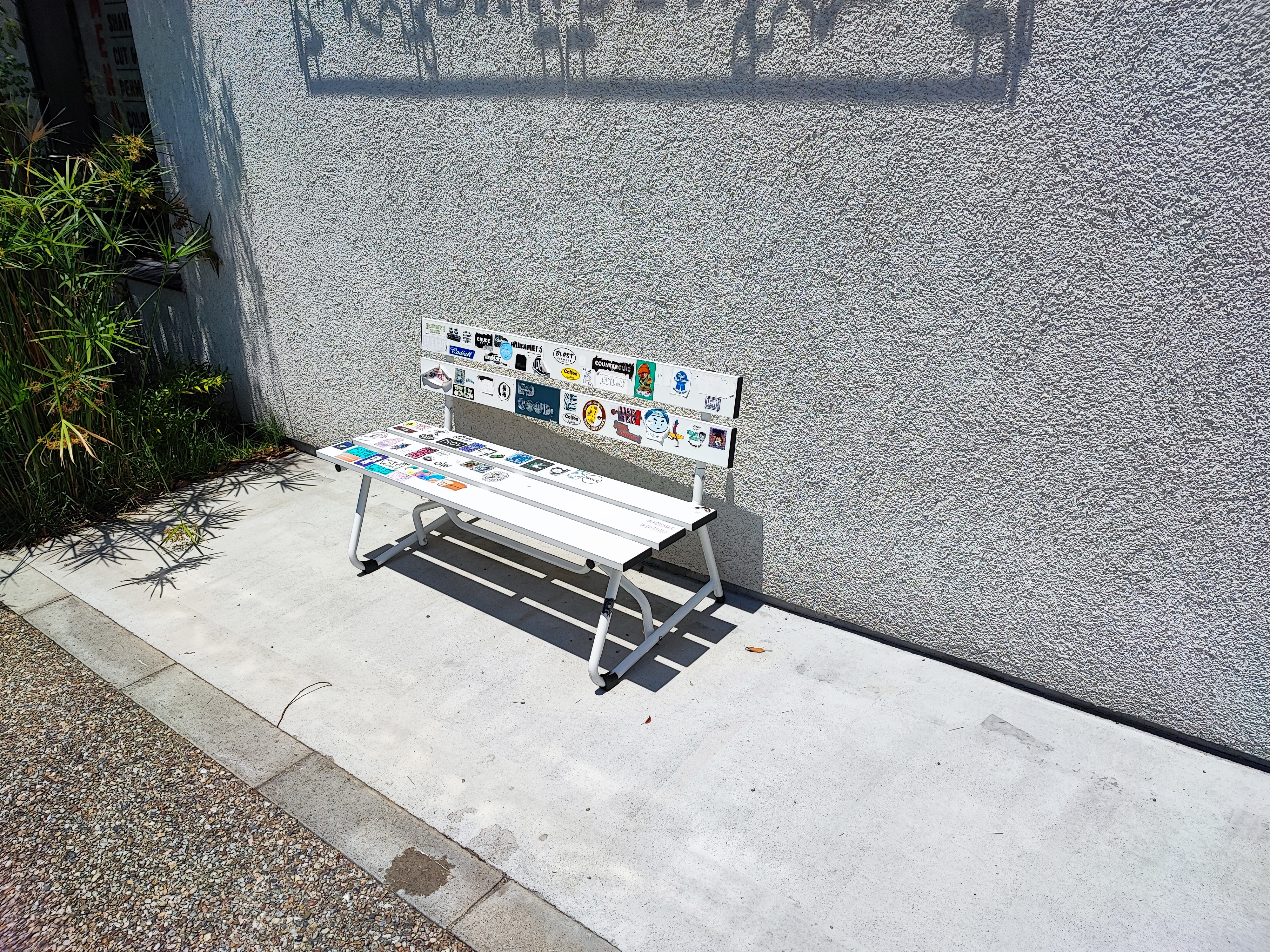 Tokyo, Simokitazawa, a white bench sitting in front of a building